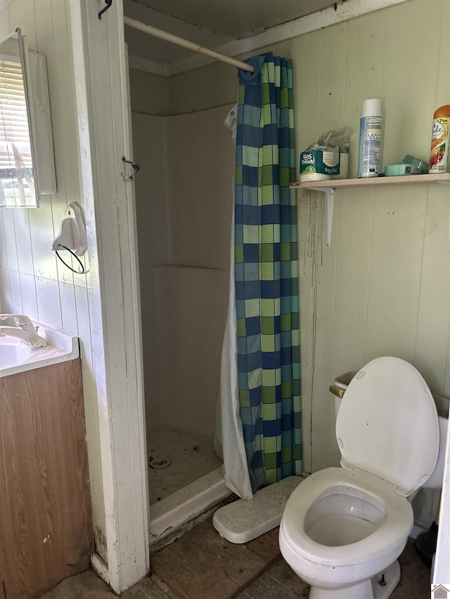 bathroom featuring toilet and a stall shower