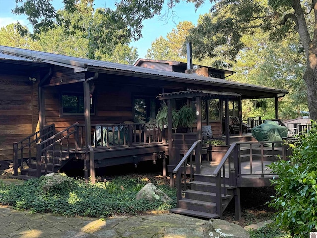 rear view of house featuring a deck