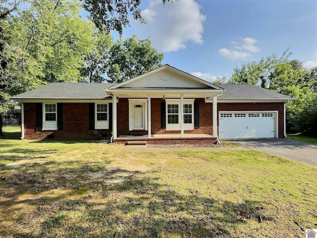 single story home with a porch, a garage, and a front yard