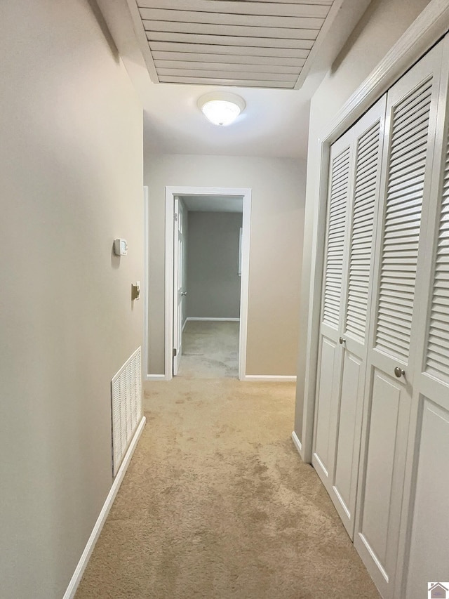 hall featuring light colored carpet