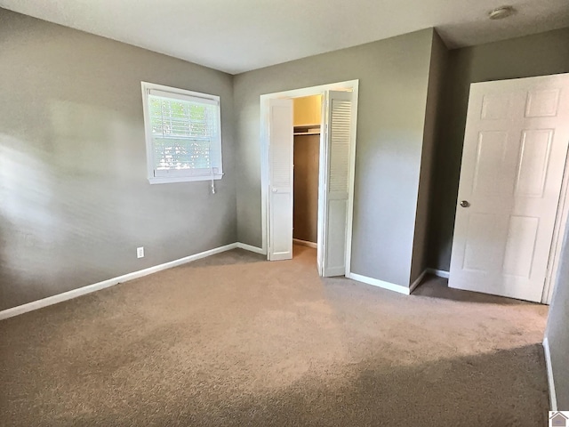 unfurnished bedroom featuring a closet and carpet floors