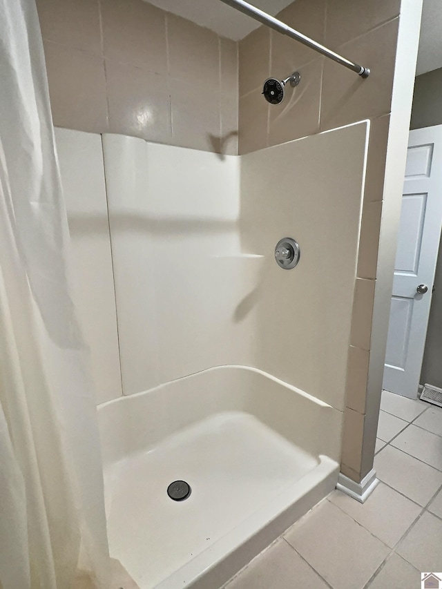 bathroom featuring a shower with shower curtain and tile patterned floors