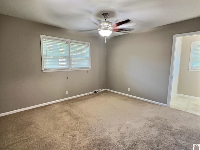 carpeted empty room with ceiling fan