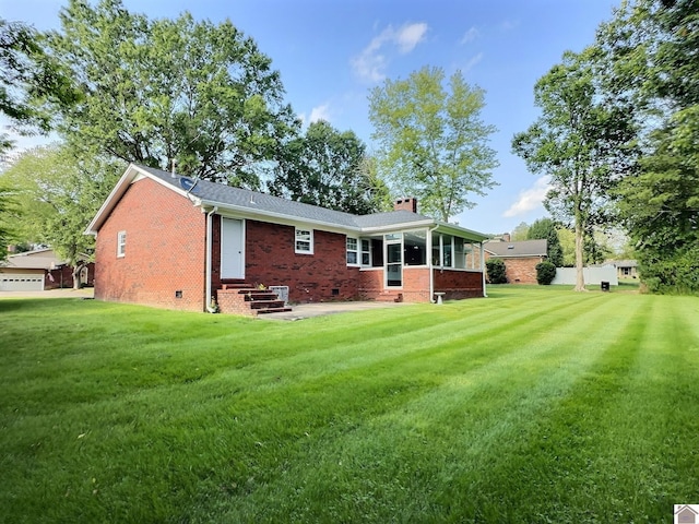 rear view of property with a yard