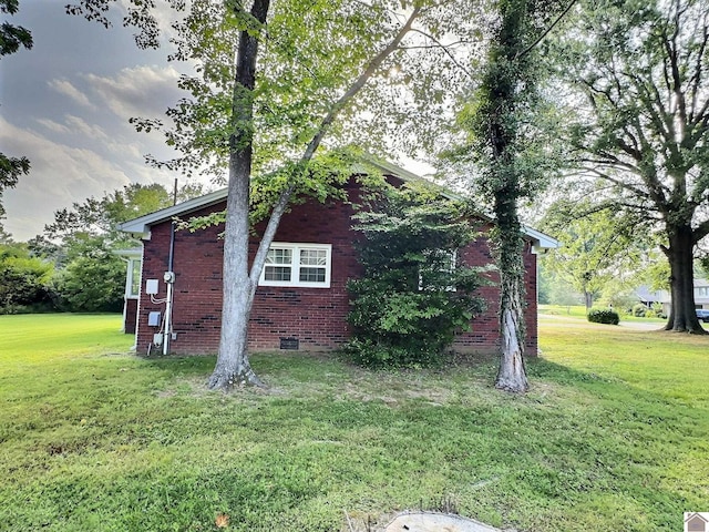 view of side of home featuring a yard