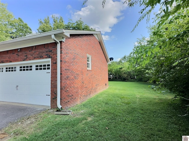 view of home's exterior featuring a garage and a lawn