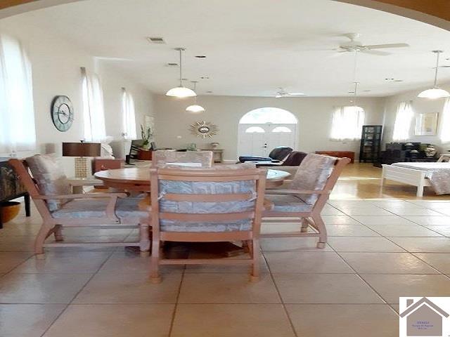 dining area with ceiling fan and light tile patterned flooring