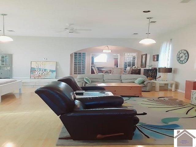 living room featuring hardwood / wood-style flooring and ceiling fan