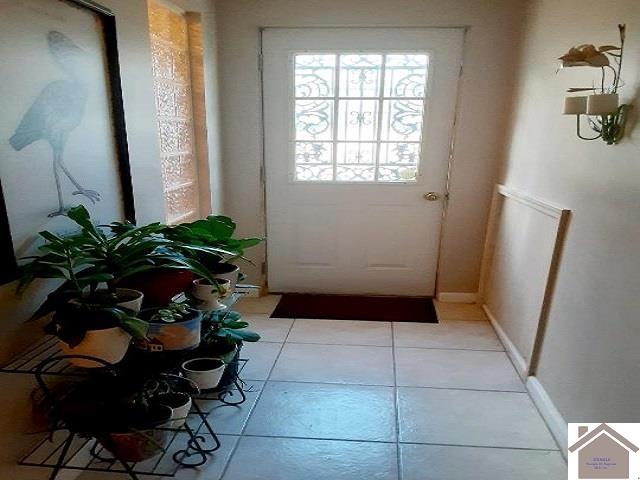 doorway to outside with light tile patterned flooring