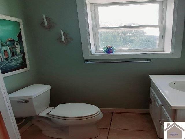 bathroom featuring a wealth of natural light, tile patterned flooring, toilet, and vanity