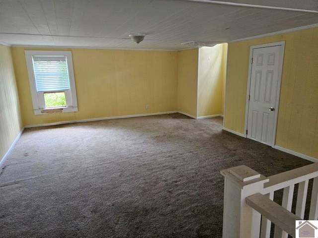 unfurnished room featuring carpet floors, crown molding, and baseboards