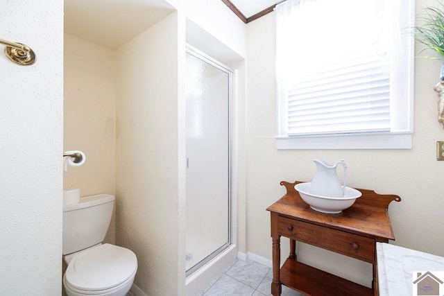 bathroom featuring toilet, an enclosed shower, tile patterned flooring, and vanity