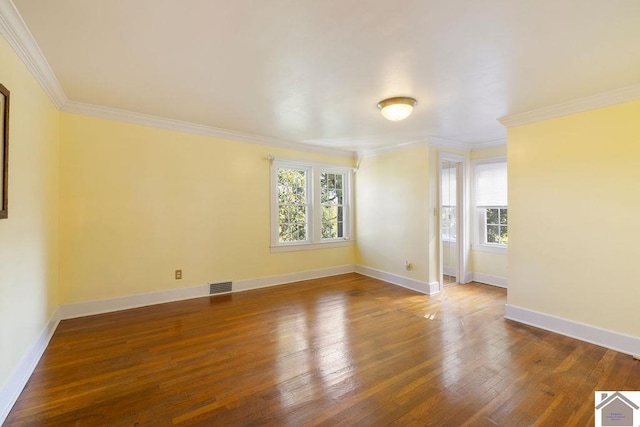spare room with crown molding, plenty of natural light, and visible vents