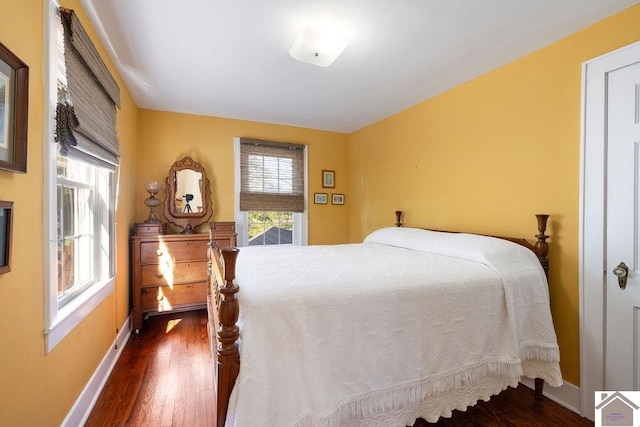 bedroom with dark hardwood / wood-style floors