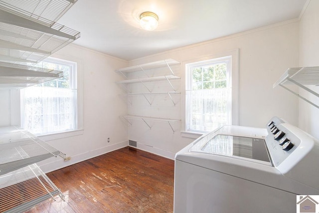 laundry area featuring washer / clothes dryer, dark hardwood / wood-style floors, and ornamental molding