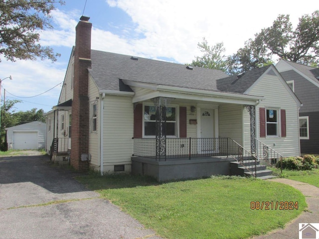 bungalow-style home with a garage, a front lawn, an outdoor structure, and covered porch