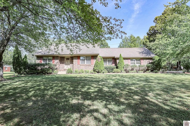 single story home featuring a front yard and brick siding