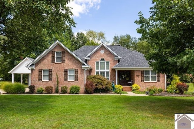 view of front facade featuring brick siding and a front lawn