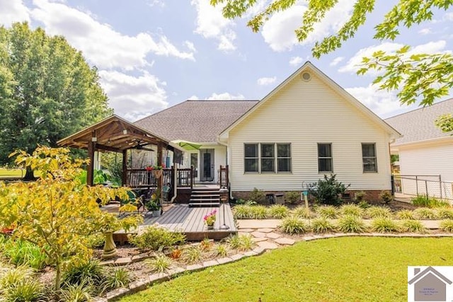 rear view of property with a yard and a deck