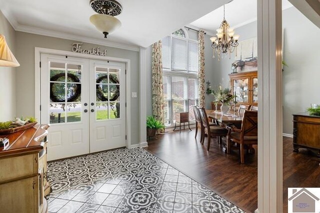 entryway with crown molding, french doors, tile patterned flooring, and a healthy amount of sunlight