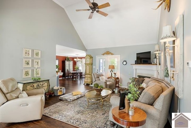 living room with high vaulted ceiling, ceiling fan with notable chandelier, and dark hardwood / wood-style flooring