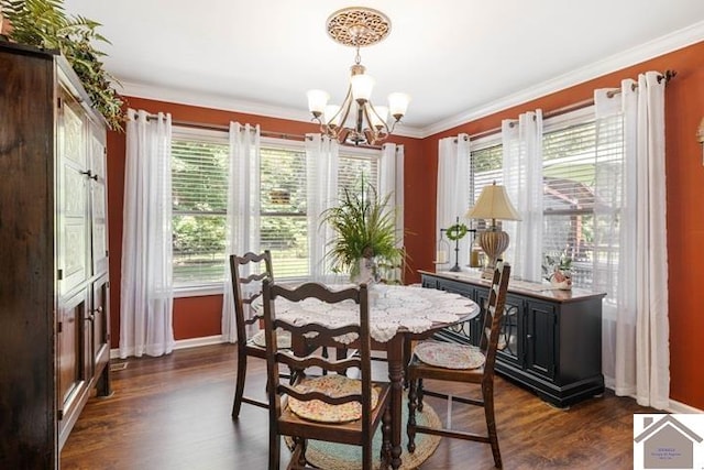 dining space featuring dark hardwood / wood-style floors, an inviting chandelier, plenty of natural light, and ornamental molding