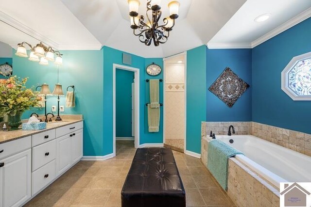 bathroom with a notable chandelier, tile patterned floors, vanity, crown molding, and a relaxing tiled tub