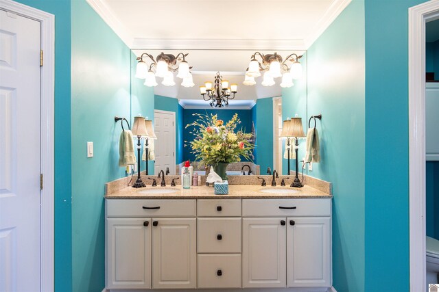 bathroom featuring a notable chandelier, crown molding, and vanity