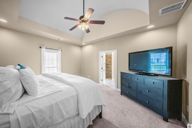 bedroom featuring carpet, high vaulted ceiling, connected bathroom, a tray ceiling, and ceiling fan