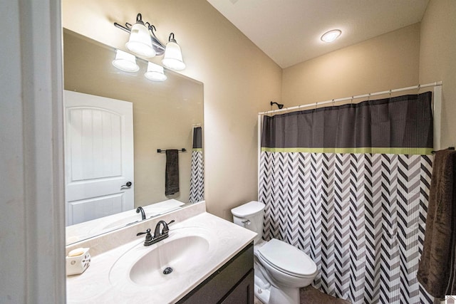 bathroom with curtained shower, vanity, and toilet