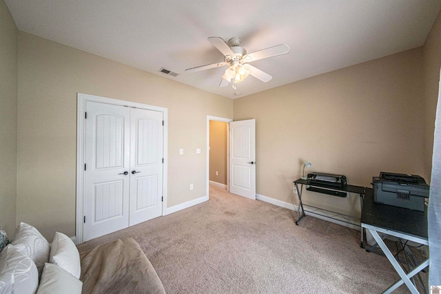 carpeted bedroom with a closet and ceiling fan