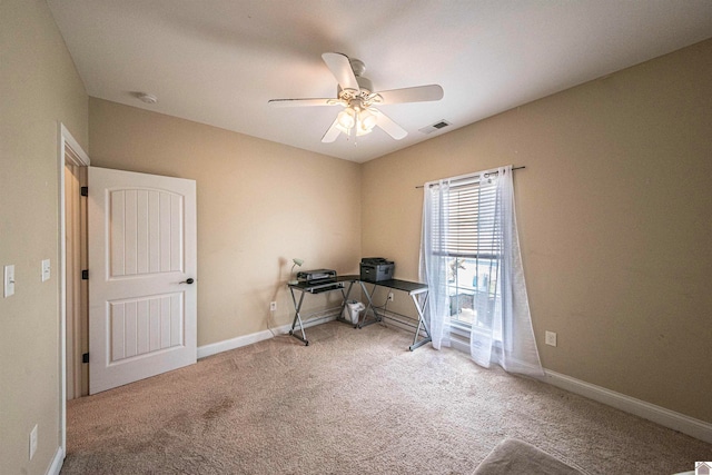 carpeted spare room with ceiling fan