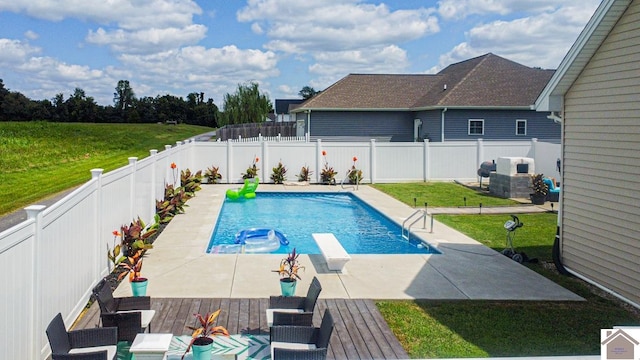 view of swimming pool with a diving board