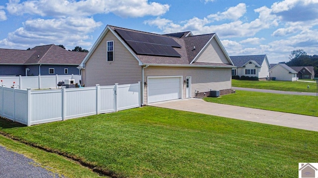 view of property exterior with solar panels and a lawn