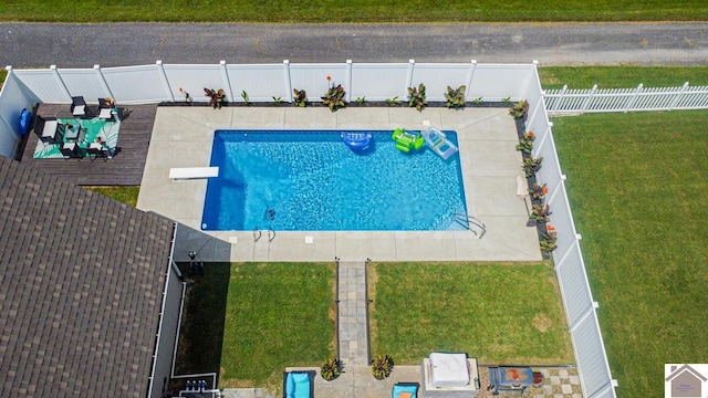 view of swimming pool featuring a diving board and a lawn