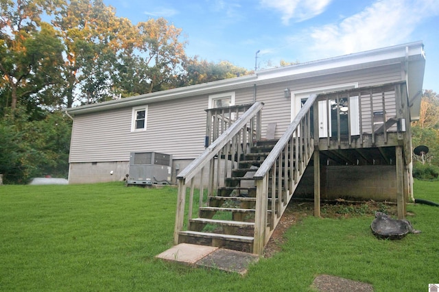 rear view of property featuring a lawn