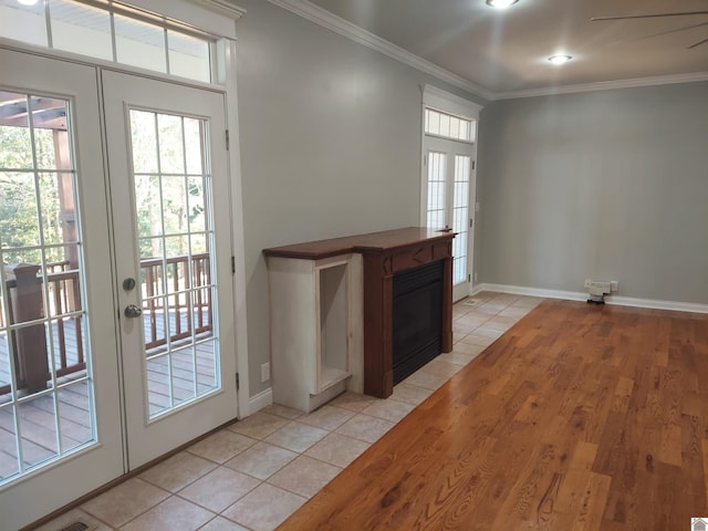 entryway featuring ornamental molding, light hardwood / wood-style floors, and french doors