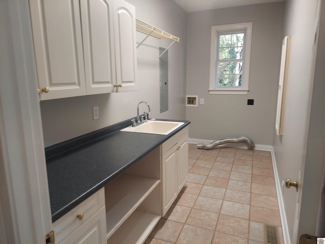 laundry room featuring washer hookup, cabinets, electric panel, sink, and light tile patterned floors