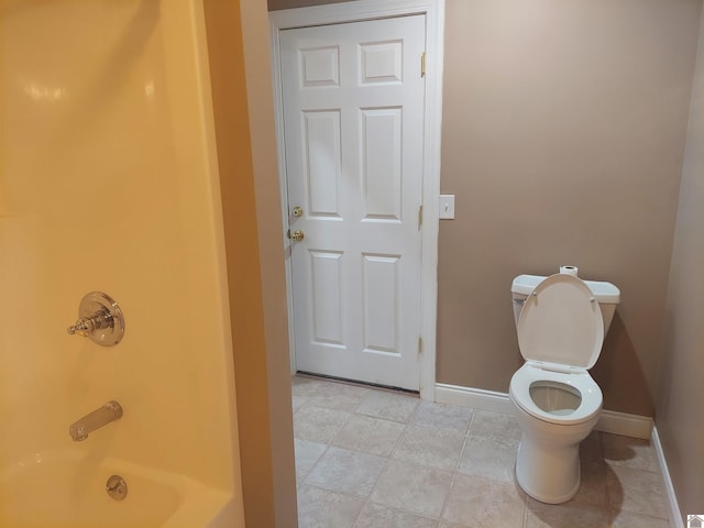 bathroom featuring tile patterned flooring,  shower combination, and toilet