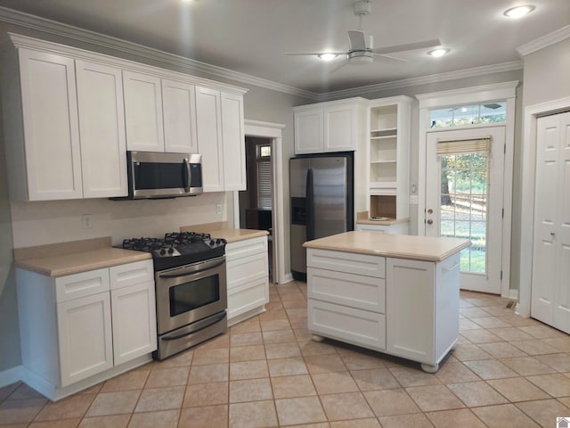 kitchen with ceiling fan, appliances with stainless steel finishes, and white cabinetry