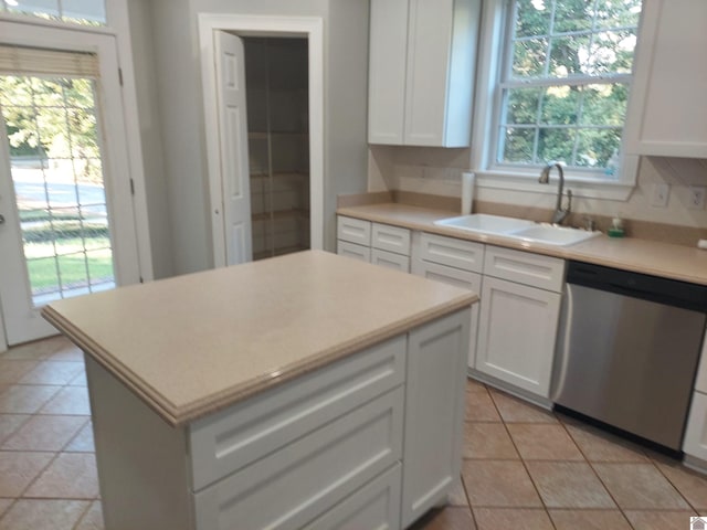 kitchen featuring white cabinets, dishwasher, a wealth of natural light, and a center island