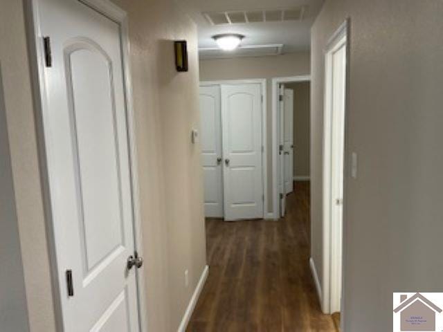 hallway featuring dark hardwood / wood-style flooring