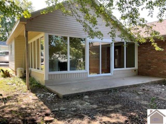 back of house featuring a sunroom