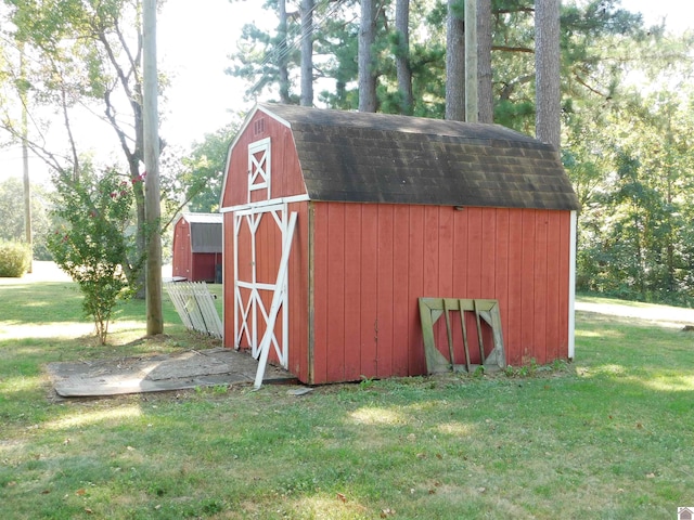 view of outbuilding featuring a lawn