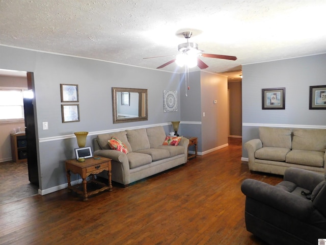 living room featuring ceiling fan, dark hardwood / wood-style floors, and a textured ceiling