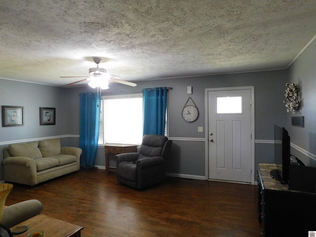 living room with ceiling fan, dark hardwood / wood-style floors, and a textured ceiling