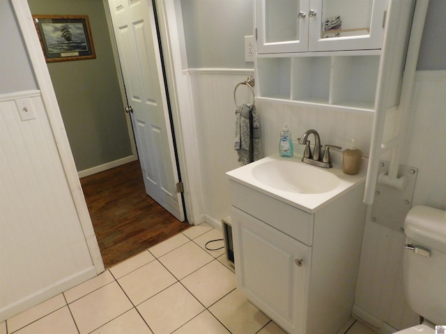 bathroom with tile patterned floors, vanity, and toilet