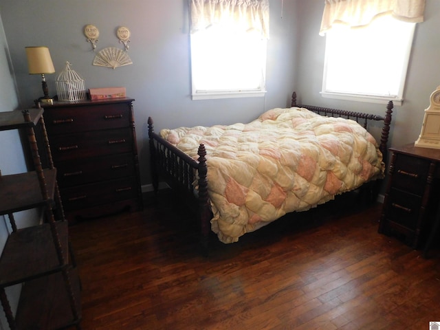 bedroom featuring dark hardwood / wood-style flooring and multiple windows