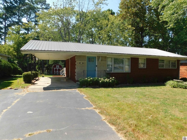 ranch-style home with a carport and a front yard