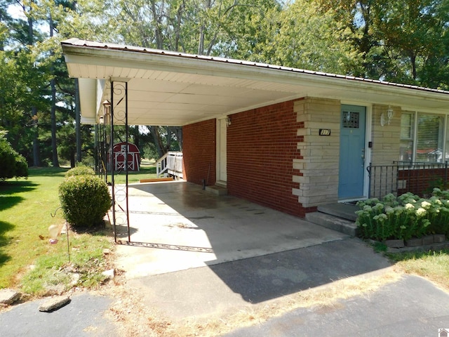 exterior space with a carport and a yard